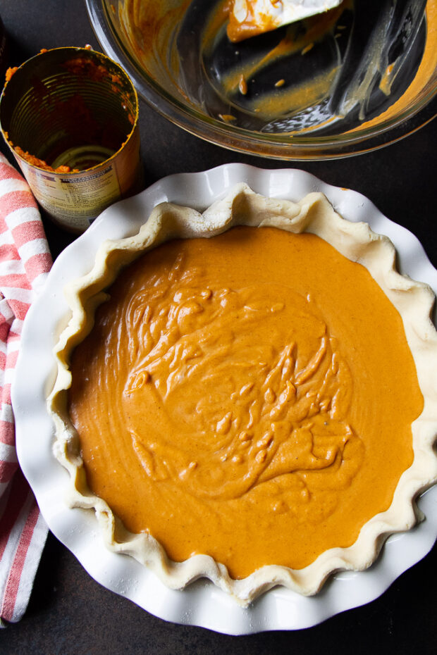 View from overhead of the filled, unbaked pumpkin pie.