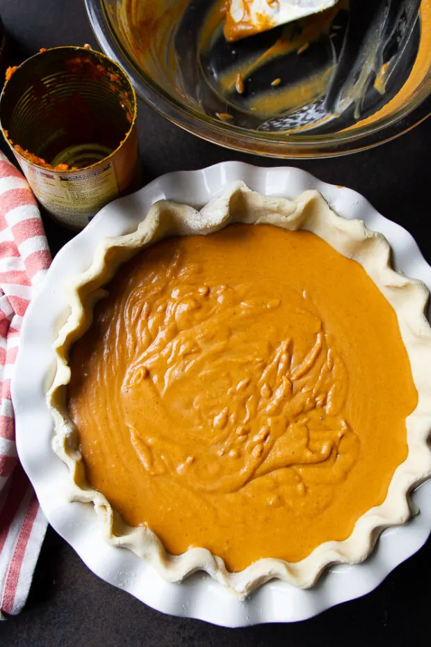 View from overhead of the filled, unbaked pumpkin pie.