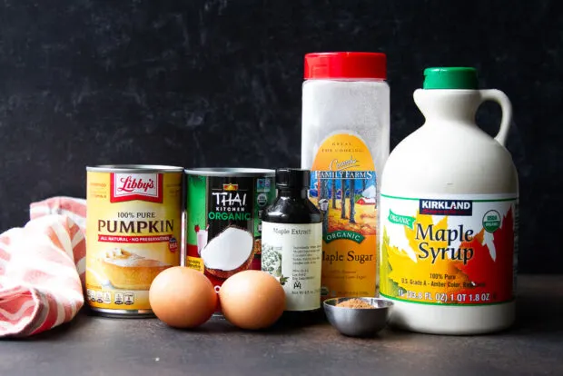 Ingredients for gluten free pumpkin pie filling: pumpkin puree, coconut milk, maple sugar, maple syrup, maple extract, chai spice, eggs.