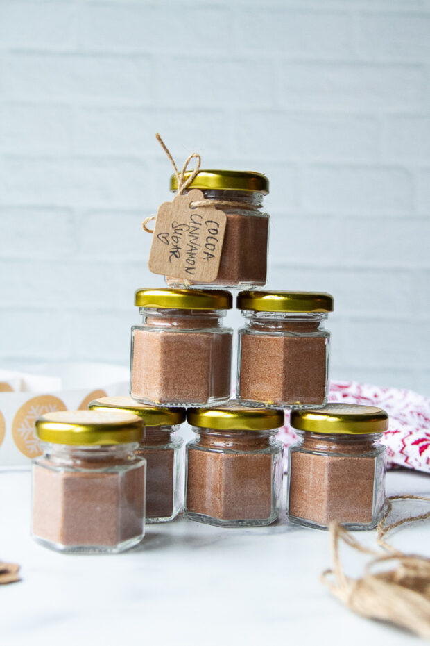 A few little jars of cinnamon sugar stacked in a pyramid.