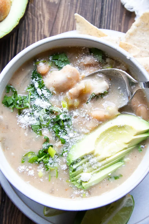 Close up of the white chicken chili finished and garnished in a bowl.