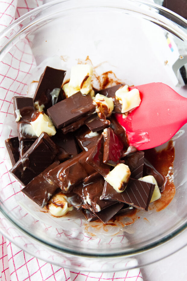 Chocolate and butter in a bowl partially melted.