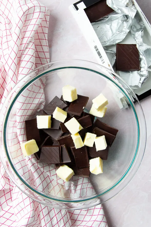 Chopped chocolate and butter in a microwave-safe bowl.