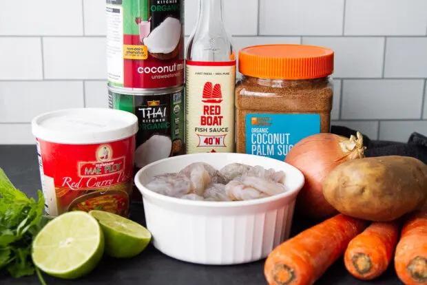 Ingredients for coconut shrimp curry: shrimp, coconut milk, curry paste, coconut sugar, fish sauce, limes, cilantro, potatoes, carrots, onion.