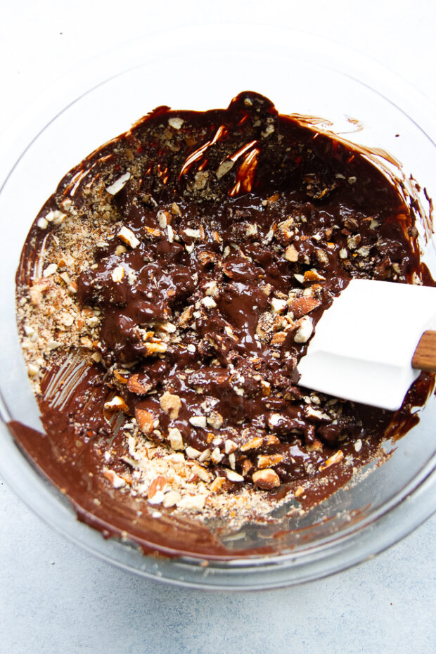 Pretzels and almonds being stirred into the chocolate.