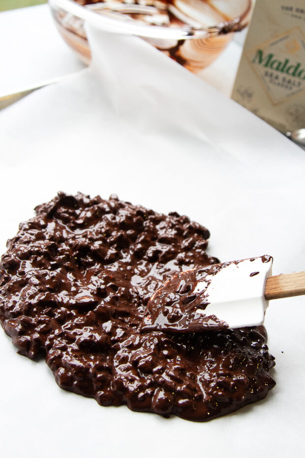 Chocolate mixture spread out on to parchment.