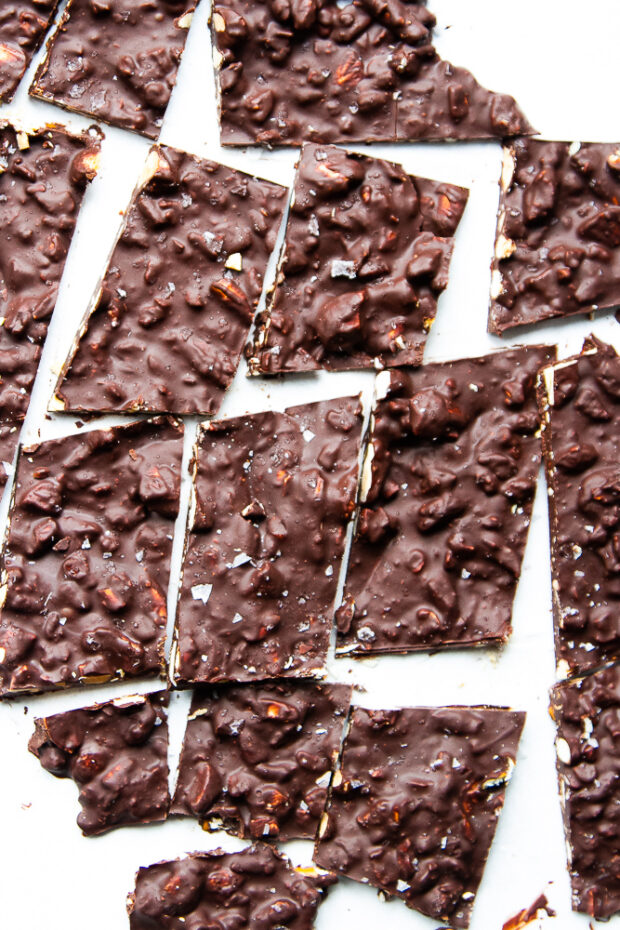 Finished dark chocolate bark cut up into chunks with a knife.