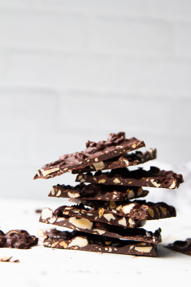 Pieces of dark chocolate bark stacked in a little tower.