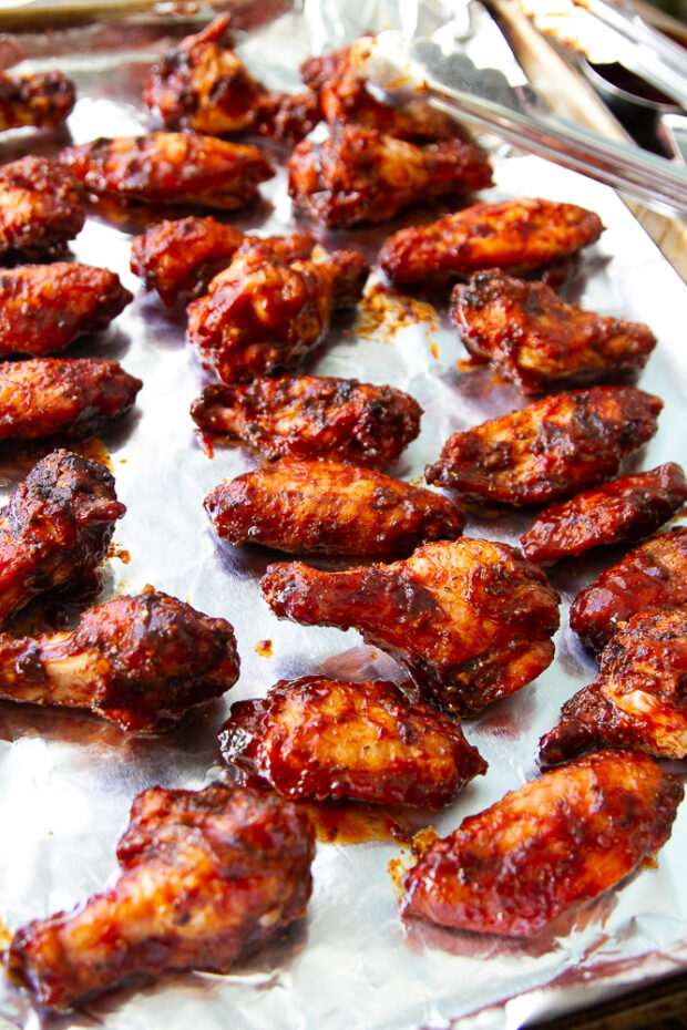 Smoked chicken wings on a foil-lined pan ready to finish off under the oven broiler.