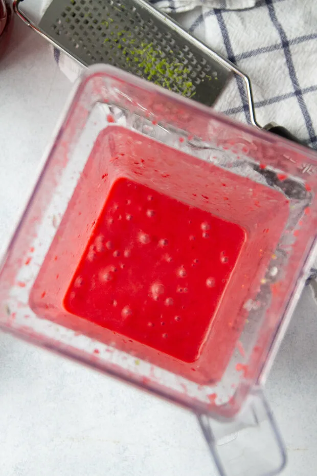 Overhead view of the same blender after the dressing has been buzzed up. It's bright fuchsia colored. 