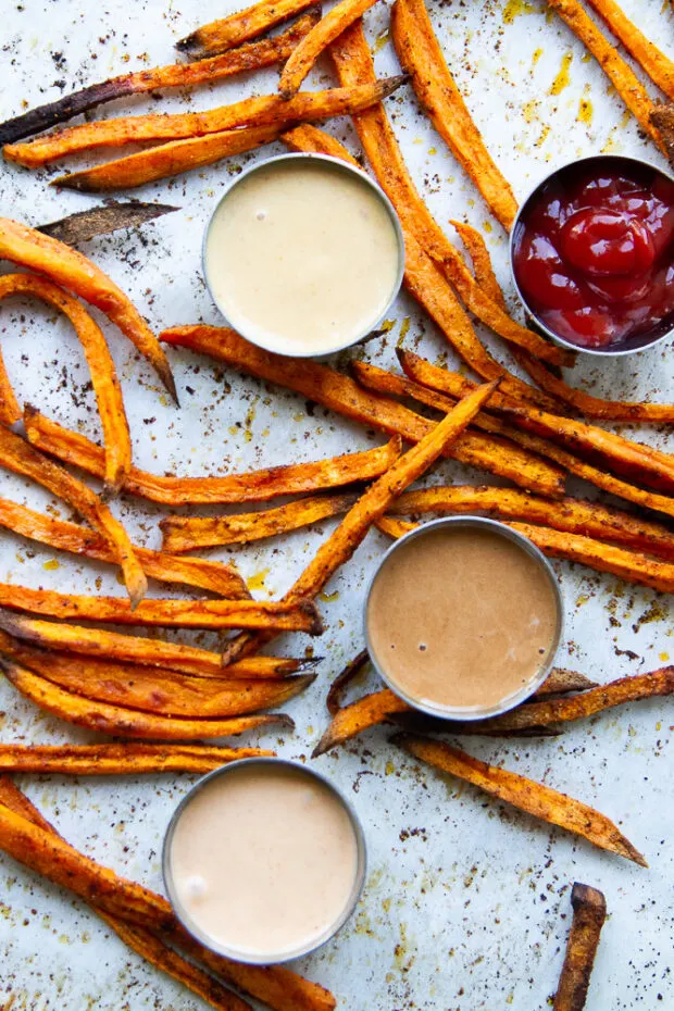 Finished sweet potato fries with little bowls of dipping sauces.