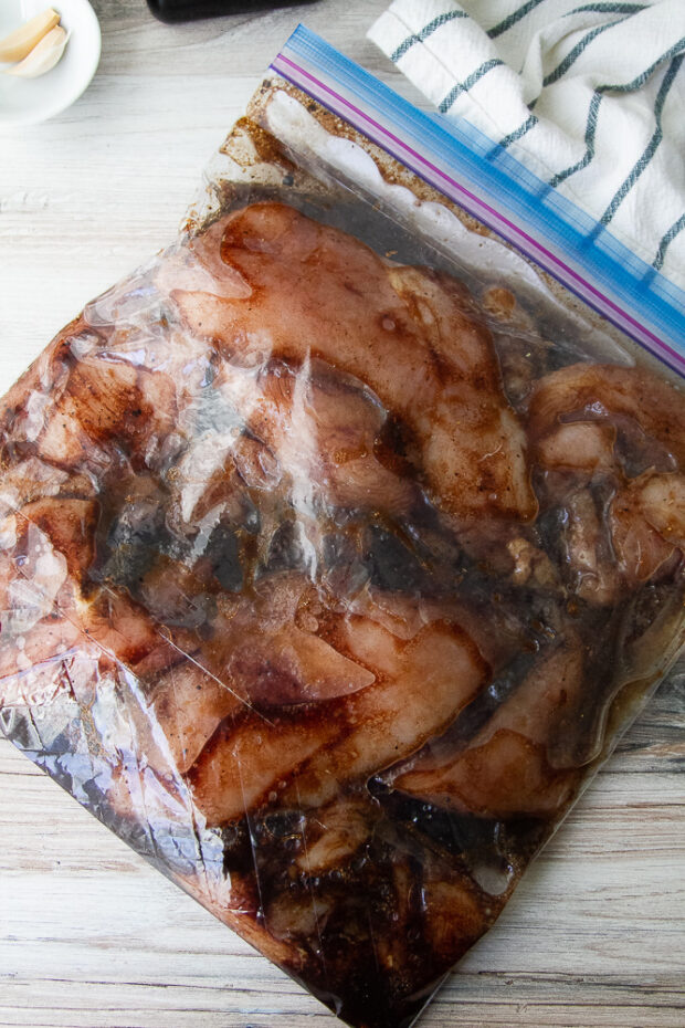 Chicken marinating in balsamic vinaigrette in a tiptop bag.