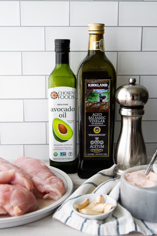 Ingredients for grilled balsamic chicken -- boneless, skinless chicken breasts, avocado oil, balsamic vinegar, fresh garlic, salt, and pepper.