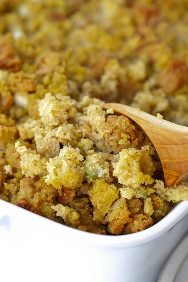 Finished cornbread with a serving spoon dipping out a serving.