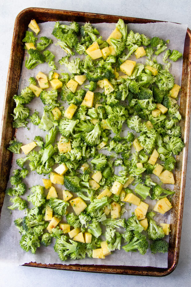 Another sheet pan with chopped broccoli & pineapple tossed in avocado oil and salt.
