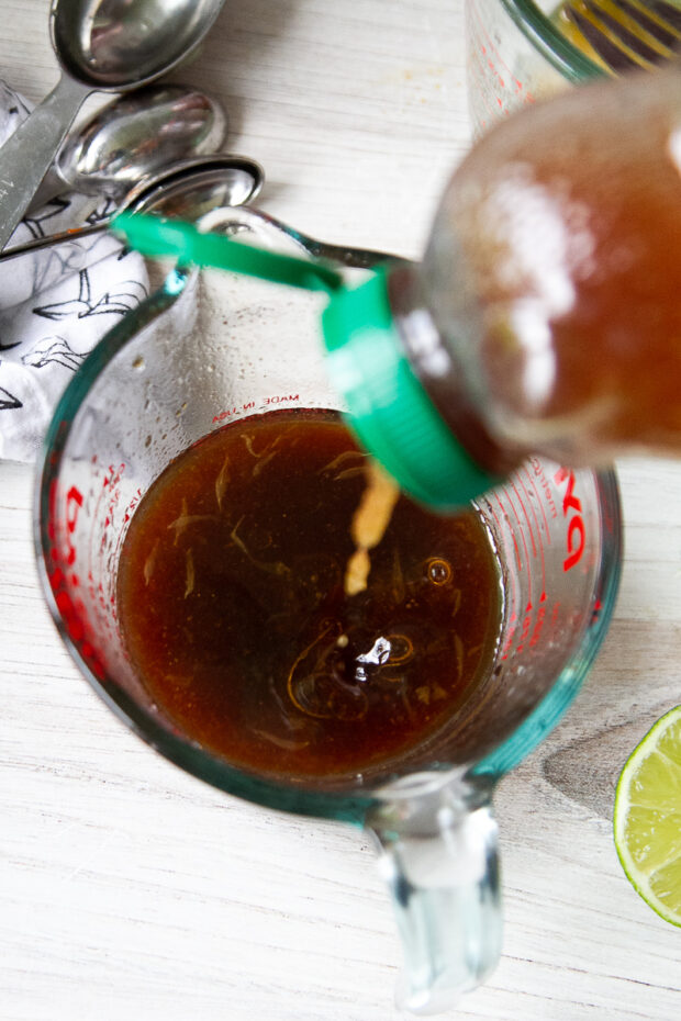 Adding honey to the reserved marinade to form a glaze.