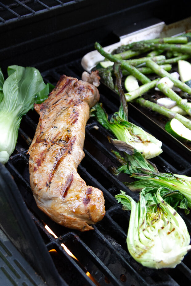 View of the pork and vegetables on the grill.