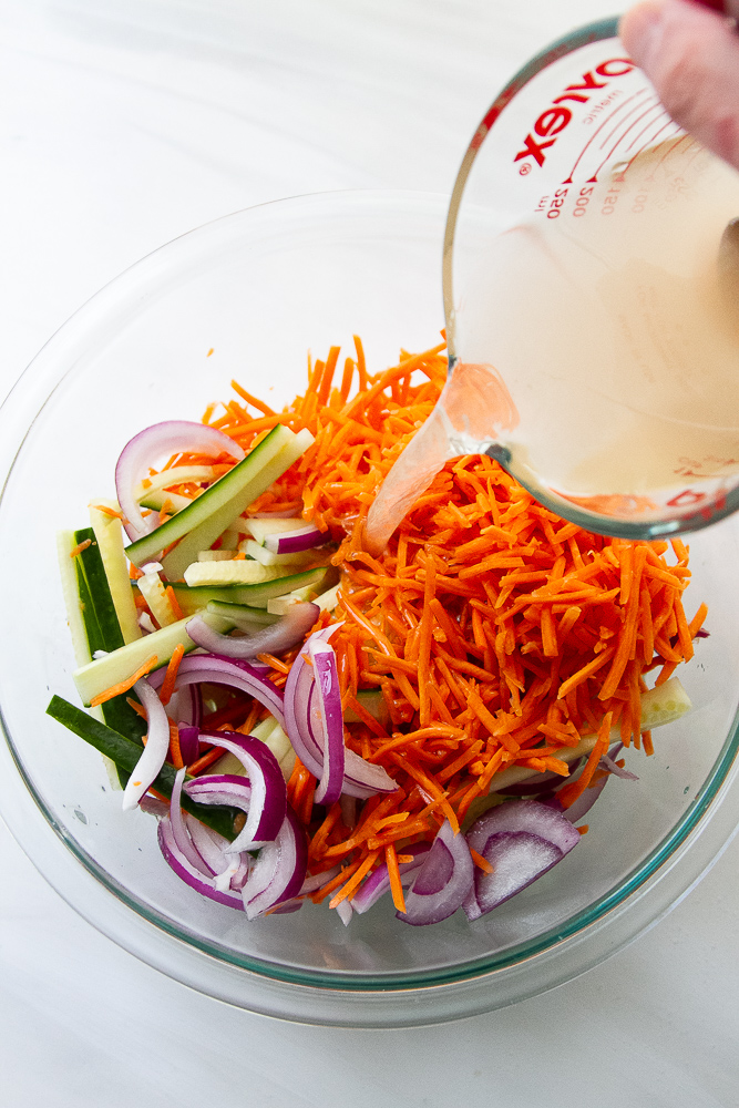 Seasoned vinegar poured over the sliced vegetables.
