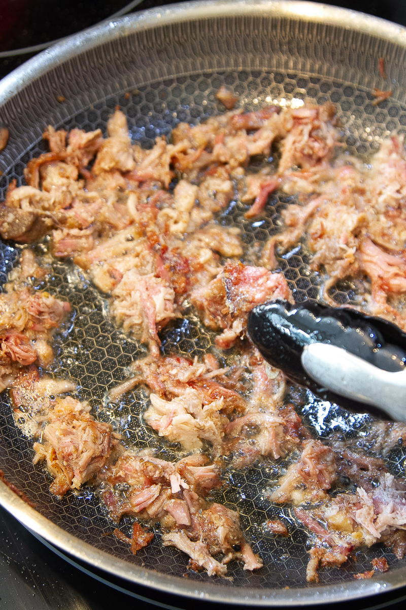 Skillet with pulled pork getting crispy