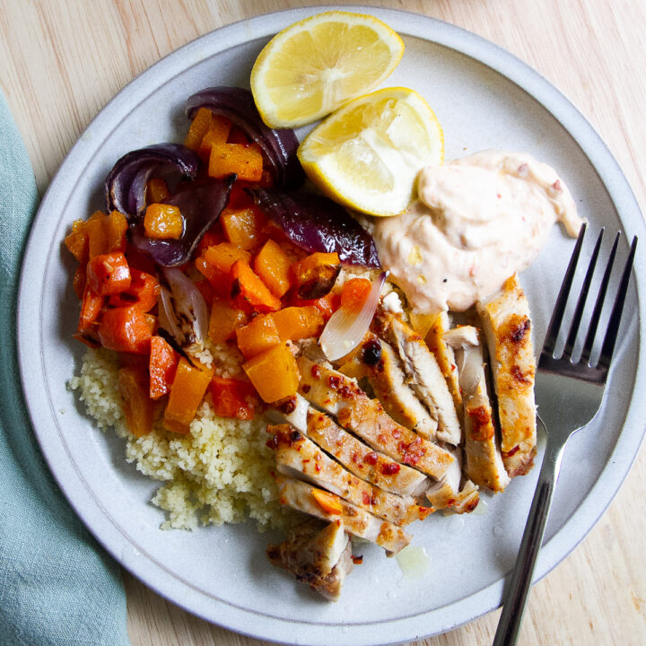 Sheet Pan Harissa Chicken Thighs with Garlic Yogurt Sauce